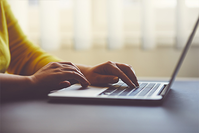 Person typing on a laptop.